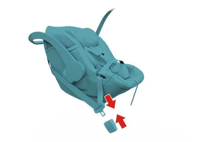 2026 Kia Tasman Child Restraint System installation image. The child safety seat and seat belt are highlighted in teal. Red arrows indicate the direction to insert the seat belt latch into the buckle. Explains the function of fastening the lap/shoulder belt latch into the buckle to secure the child restraint system.