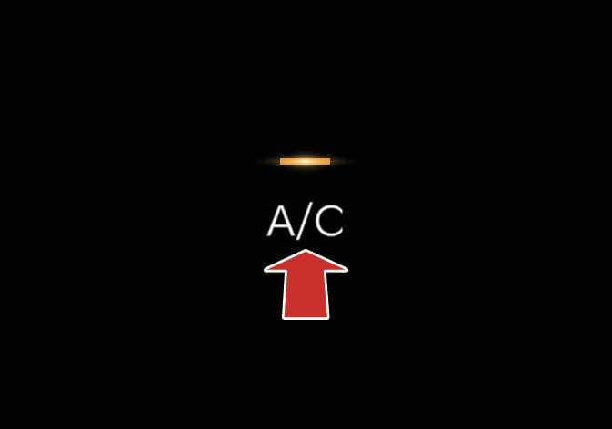 2026 Kia Tasman Air conditioning A/C icon image. The 'A/C' text is displayed with an orange indicator light above it. A red arrow points upward towards the text. Explains the function of operating the air conditioning system by touching the icon.