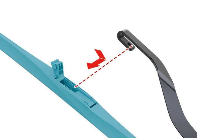 2026 Kia Tasman front wiper blade replacement image. The wiper blade is highlighted in teal. A red arrow indicates the motion of pulling the blade assembly down to disengage it from the black U-shaped wiper arm hook. A red dotted line traces the alignment. Explains the step of removing the wiper blade.