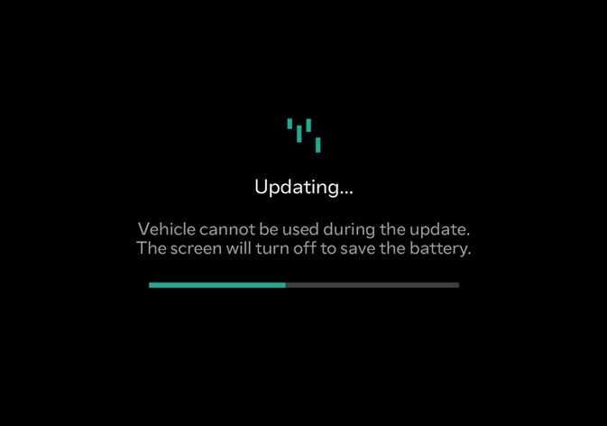 2026 Kia Tasman software update screen image. The screen displays 'Updating...' text, a warning message 'Vehicle cannot be used during the update,' and a teal progress bar. This explains the screen shown during the software update process.