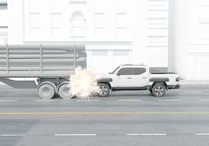 2026 Kia Tasman air bag non-inflation condition image. A white pickup truck brakes heavily and slides under a large truck trailer loaded with pipes. This illustrates an under-ride situation where air bags may not inflate due to reduced deceleration forces detected by sensors.