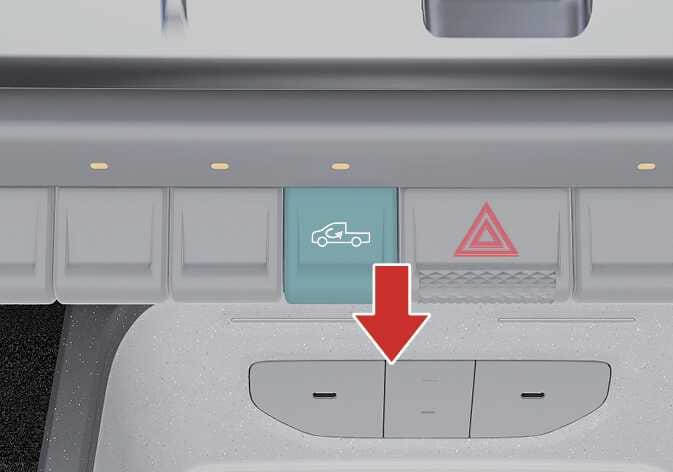 2026 Kia Tasman air intake control lever image. The lever featuring a car icon with a curved arrow is highlighted in teal. A red arrow points downward, indicating the direction to press the lever. Explains the function of selecting the outside or recirculated air position.
