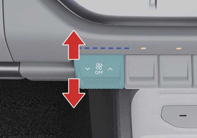 2026 Kia Tasman fan speed control lever image. The lever, highlighted in teal, displays a fan icon and 'OFF' text. Red vertical arrows point up and down to indicate the direction of operation. Describes the function of adjusting the ventilation fan speed.