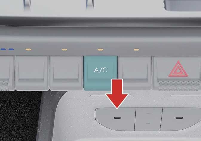 2026 Kia Tasman Air conditioning (A/C) lever image. The A/C switch is highlighted in teal, and a red arrow points downwards to indicate the pressing action. Explains the function of pressing the lever to turn the air conditioning system on or off.