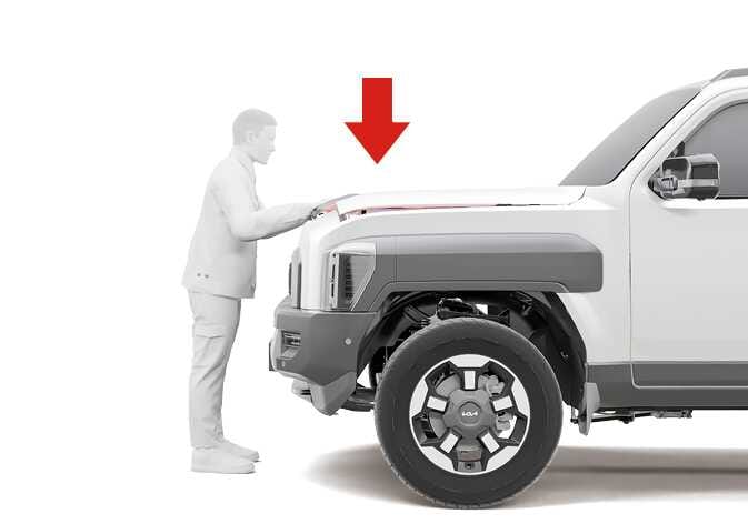 2026 Kia Tasman hood closing image. A person is depicted standing at the front of the vehicle, lowering the hood, with a thick red arrow pointing downwards. Explains the function of closing the hood.