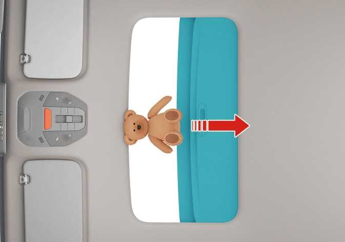 2026 Kia Tasman sunroof automatic reversal function image. A teddy bear is placed as an obstacle between the sunroof glass highlighted in teal and the roof panel. A red arrow indicates the closing direction. Describes the function where the sunroof detects an obstacle and reverses direction to prevent injury or damage.