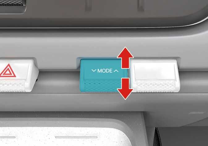 Image of the 2026 Kia Tasman air flow mode selection switch. The switch labeled 'MODE' is highlighted in teal, with red vertical arrows indicating the upward and downward operation direction. This explains the function of selecting the direction of the air flow through the ventilation system.