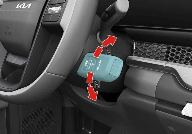 2026 Kia Tasman gear shift lever image. The column-mounted shift lever is highlighted in teal. Red curved arrows indicate rotating the knob to the 'N' position. This explains the function of shifting the vehicle into Neutral.