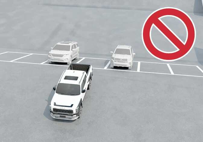 2026 Kia Tasman Remote Smart Parking Assist limitation image. A white pickup truck is shown on an inclined road near parked vehicles, with a large red prohibition symbol in the upper right. Explains the limitations of the parking assist function on slopes.