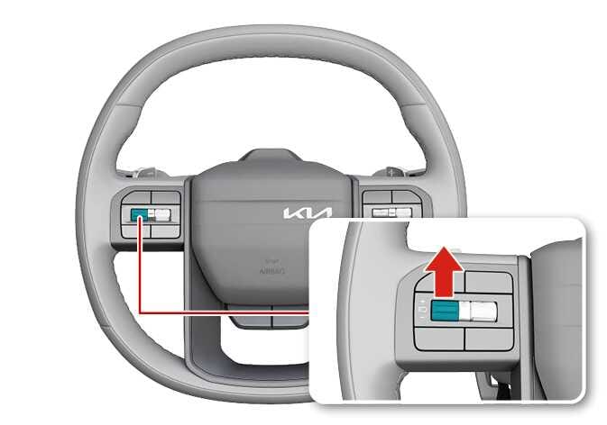 2026 Kia Tasman steering wheel cruise control switch image. The speed control switch on the left spoke is highlighted in teal. A red arrow in the inset points upward, indicating to push the switch up. This explains the function of increasing the cruise control set speed.