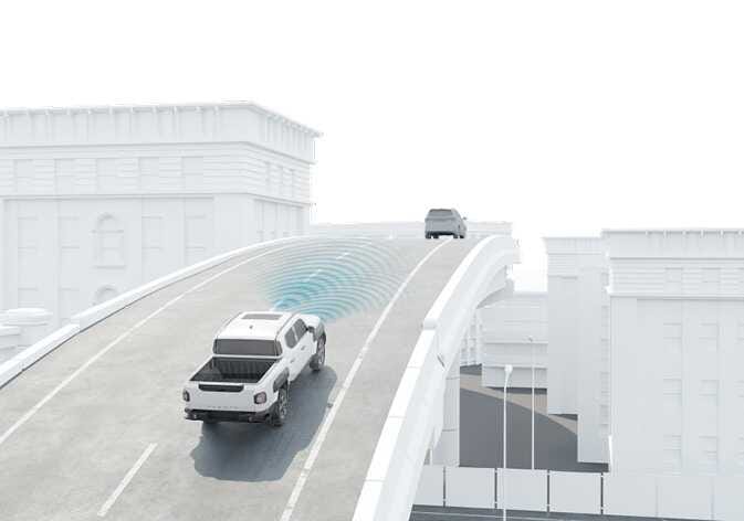 2026 Kia Tasman Smart Cruise Control limitation on a curved road image. A white pickup truck drives on a curved overpass, emitting blue radar waves from the front to detect a vehicle ahead. It explains the function regarding sensor detection capabilities and limitations on curved roads.
