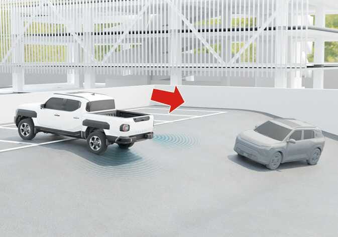 2026 Kia Tasman Rear Cross-Traffic Collision-Avoidance Assist limitation image. A white truck reverses into a parking spot, indicated by a red arrow. Blue radar waves emit from the rear near a grey SUV. This describes a limitation when backing into a parking space.
