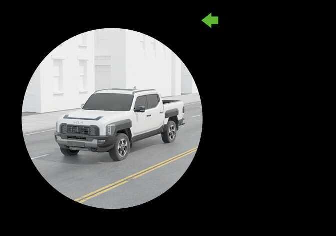 2026 Kia Tasman Blind-Spot View Monitor (BVM) image. A white vehicle is displayed within a circular frame, and a green arrow icon points to the left. This illustrates the function that displays the rear blind spot area in the instrument cluster when the turn signal is activated to help safely change lanes.