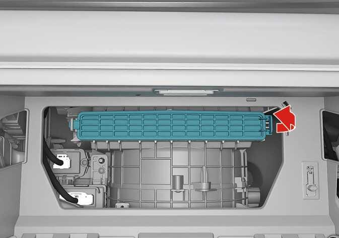 2026 Kia Tasman climate control air filter cover image. The air filter cover is highlighted in teal within the open glove box. A red arrow points to the right at the side latch, indicating the direction to pull to release the cover. This explains the function of removing the climate control air filter cover.