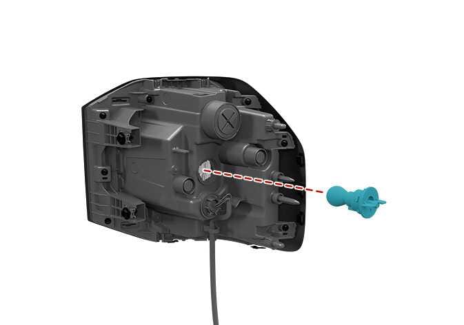 2026 Kia Tasman rear turn signal lamp replacement image. The rear side of the rear combination lamp assembly is shown. A bulb socket, highlighted in teal, is depicted being pulled out from the assembly along a red dashed line. Explains the process of removing the socket from the assembly.