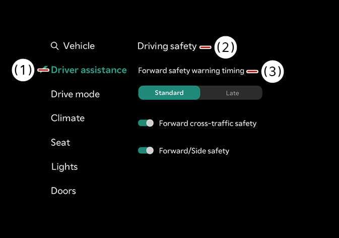 2026 Kia Tasman Forward Safety Warning Timing settings screen image. Callout (1) indicates 'Driver assistance', (2) 'Driving safety', and (3) 'Forward safety warning timing'. 'Standard' is highlighted in teal. Explains the function of adjusting the warning activation timing.