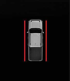 2026 Kia Tasman Side Parking Distance Warning infotainment display image. Solid red lines are displayed along both sides of the top-down vehicle view. This explains the screen indication when an obstacle is detected within 30 cm (12 in).
