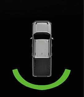 2026 Kia Tasman Reverse Parking Distance Warning infotainment screen image. A green curved line appears behind the rear bumper of the vehicle shown in a top-down view. This describes the warning indicator displayed when an object is detected at a distance of 60 to 120 cm.