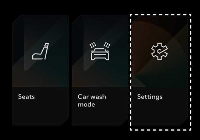 2026 Kia Tasman infotainment system menu screen image. It displays 'Seats', 'Car wash mode', and 'Settings' icons on a black background. The 'Settings' menu, represented by a gear icon, is highlighted with a white dashed box. Explains the function of selecting the Settings menu.