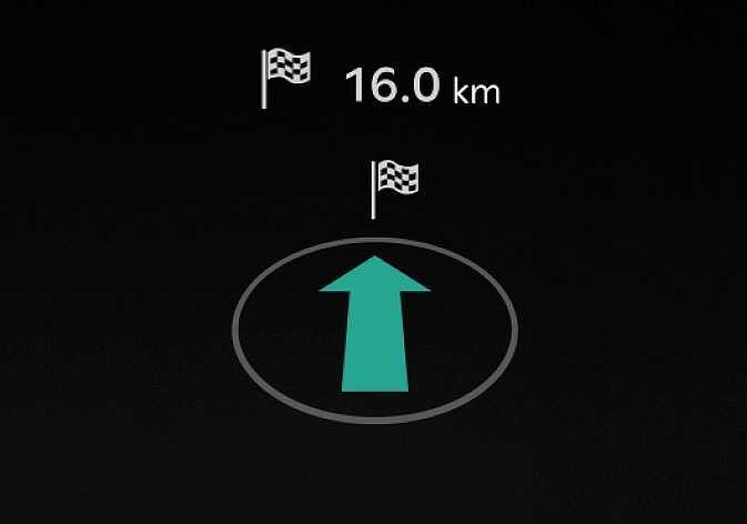 2026 Kia Tasman Navigation view image. A large teal upward arrow inside a grey oval indicates the driving direction. Above it, a checkered flag icon with the text '16.0 km' shows the remaining distance. Explains the function of displaying the navigation status on the LCD display.