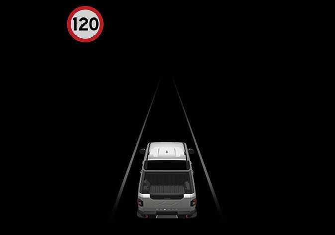 2026 Kia Tasman instrument cluster display image. A white vehicle is depicted driving between two lane lines in the center, and a speed limit sign with the number '120' inside a red circle is displayed in the upper left corner. This describes the function of displaying speed limit information on the instrument cluster.