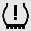 2026 Kia Tasman Low Tire Pressure Warning Light icon. A U-shaped symbol resembling a tire cross-section with treads at the bottom and an exclamation mark in the center. Explains the function of warning the driver when tire pressure is low.