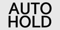 2026 Kia Tasman Auto Hold indicator light icon. It displays the text 'AUTO' stacked above 'HOLD' in bold uppercase letters. This symbol indicates the status of the Auto Hold system, which keeps the vehicle stationary even after the brake pedal is released.