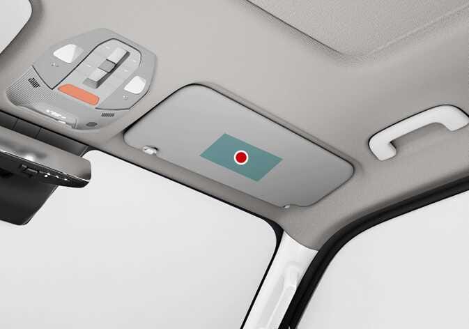 2026 기아 타스만 에어백 경고 라벨 위치 이미지입니다. 차량 실내 천장의 동승석 선바이저에 청록색으로 강조된 사각형 영역과 붉은색 점이 표시되어 있습니다. 에어백 경고 라벨이 부착된 위치를 확인하는 기능을 설명합니다.