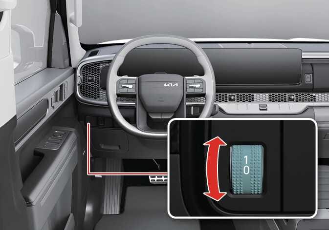 2026 기아 타스만 전조등 각도 조절장치 이미지입니다. 스티어링 휠 왼쪽에 청록색으로 강조된 조절 휠이 있습니다. 상세도에는 숫자 0, 1이 적힌 휠과 위아래 조작을 지시하는 붉은색 화살표가 표시되어 있습니다. 휠을 움직여 전조등 각도를 조절하는 기능을 설명합니다.