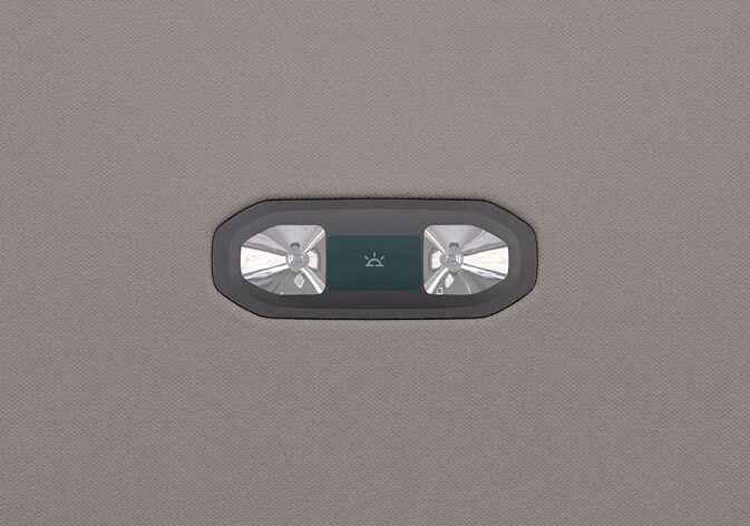 2026 기아 타스만 룸램프 이미지입니다. 차량 천장에 장착된 램프의 양쪽에는 조명이 있고, 중앙에는 조명 아이콘이 그려진 검은색 버튼이 배치되어 있습니다. 버튼을 눌러 뒷좌석 램프를 켜거나 끄는 작동 방법을 설명합니다.