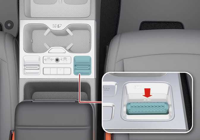 2026 기아 타스만 험로 저속 크루즈 컨트롤(X-TREK) 버튼 조작 이미지입니다. 센터 콘솔 조작부의 우측 버튼이 청록색으로 강조되어 있으며, 상세도에는 붉은색 화살표가 버튼을 누르는 방향을 지시하고 있습니다. 버튼을 눌러 기능을 켜는 방법을 설명합니다.