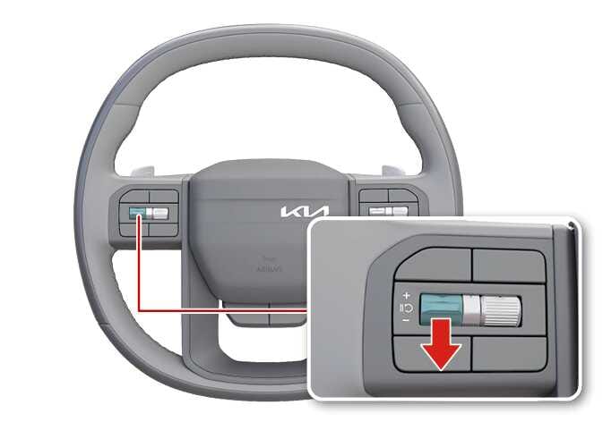 2026 기아 타스만 스티어링 휠의 스마트 크루즈 컨트롤 속도 조절 스위치 이미지입니다. 스티어링 휠 좌측 리모컨에 위치한 토글 스위치가 청록색으로 강조되어 있으며, 상세도에는 스위치를 아래로 내리는 동작을 붉은색 화살표로 지시하고 있습니다. 스위치를 아래로 내려 주행 속도를 설정하거나 감속하는 기능을 설명합니다.