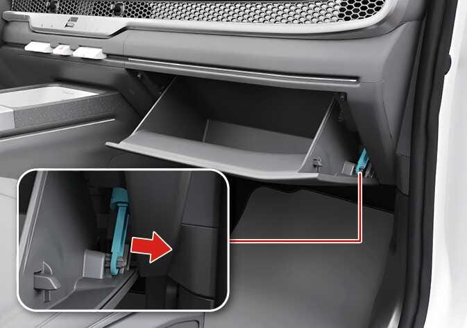 This image shows the removal of the glovebox support bracket for the 2026 Kia Tasman. It includes a close-up detail of the right side with the glovebox open. The detail shows the support bracket connection highlighted in turquoise being pulled to the right, in the direction of the red arrow. This explains the process of opening the glovebox and removing the right side support bracket.
