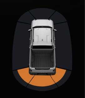 2026 기아 타스만 후방 주차 거리 경고 클러스터 화면 이미지입니다. 차량 평면도 후방의 부채꼴 감지 영역 중 중간 부분이 주황색으로 표시되어 있습니다. 후방 물체와의 거리가 30~60 cm일 때 클러스터에 경고를 표시하는 기능을 설명합니다.