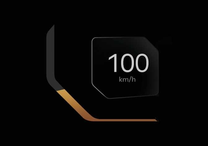 2026 기아 타스만 속도계 B 타입 이미지입니다. 검은색 배경의 육각형 디스플레이 중앙에 흰색 숫자로 '100'과 그 아래 'km/h' 단위가 표시되어 있습니다. 화면 좌측 하단에는 주황색 그래픽 라인이 디자인되어 있습니다. 차량의 현재 주행 속도를 디지털 숫자로 확인하는 기능을 설명합니다.